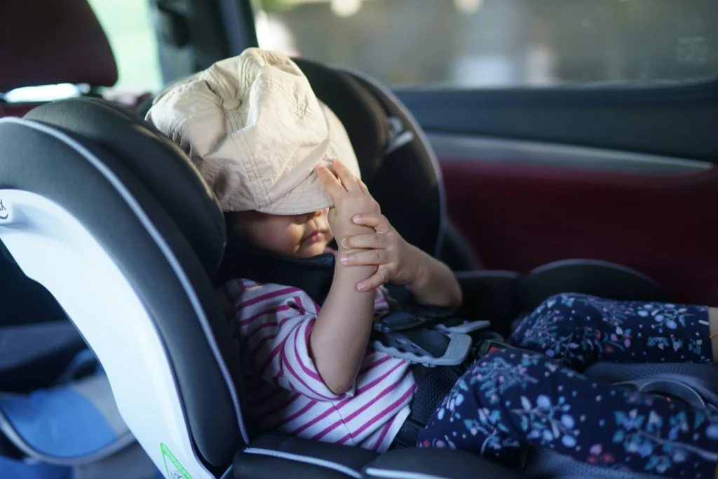 A young child travelling in a child seat