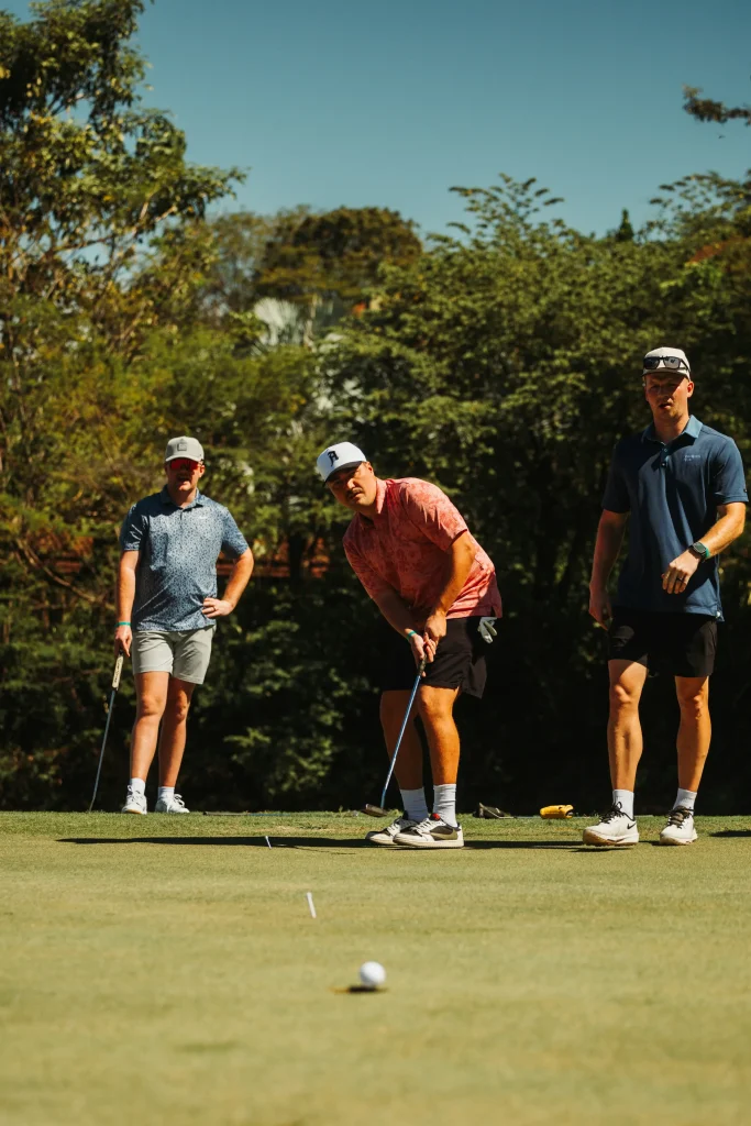 Golfers preparing a shot on a golf course